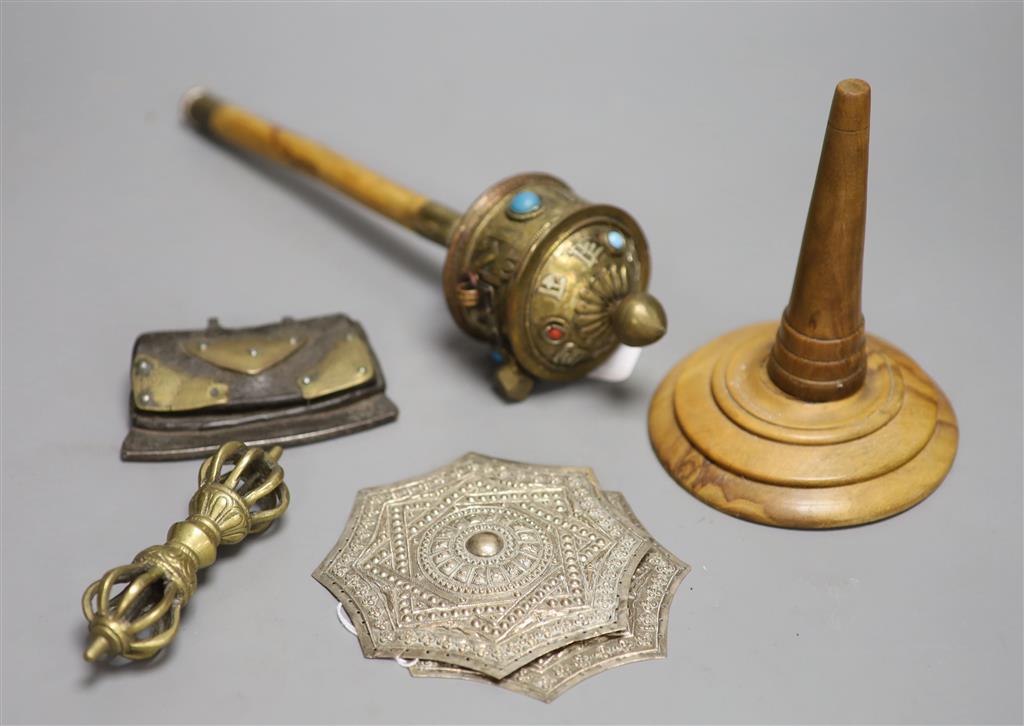 A Tibetan brass prayer wheel, inset with cabochons, with turned wood handle and four other items,